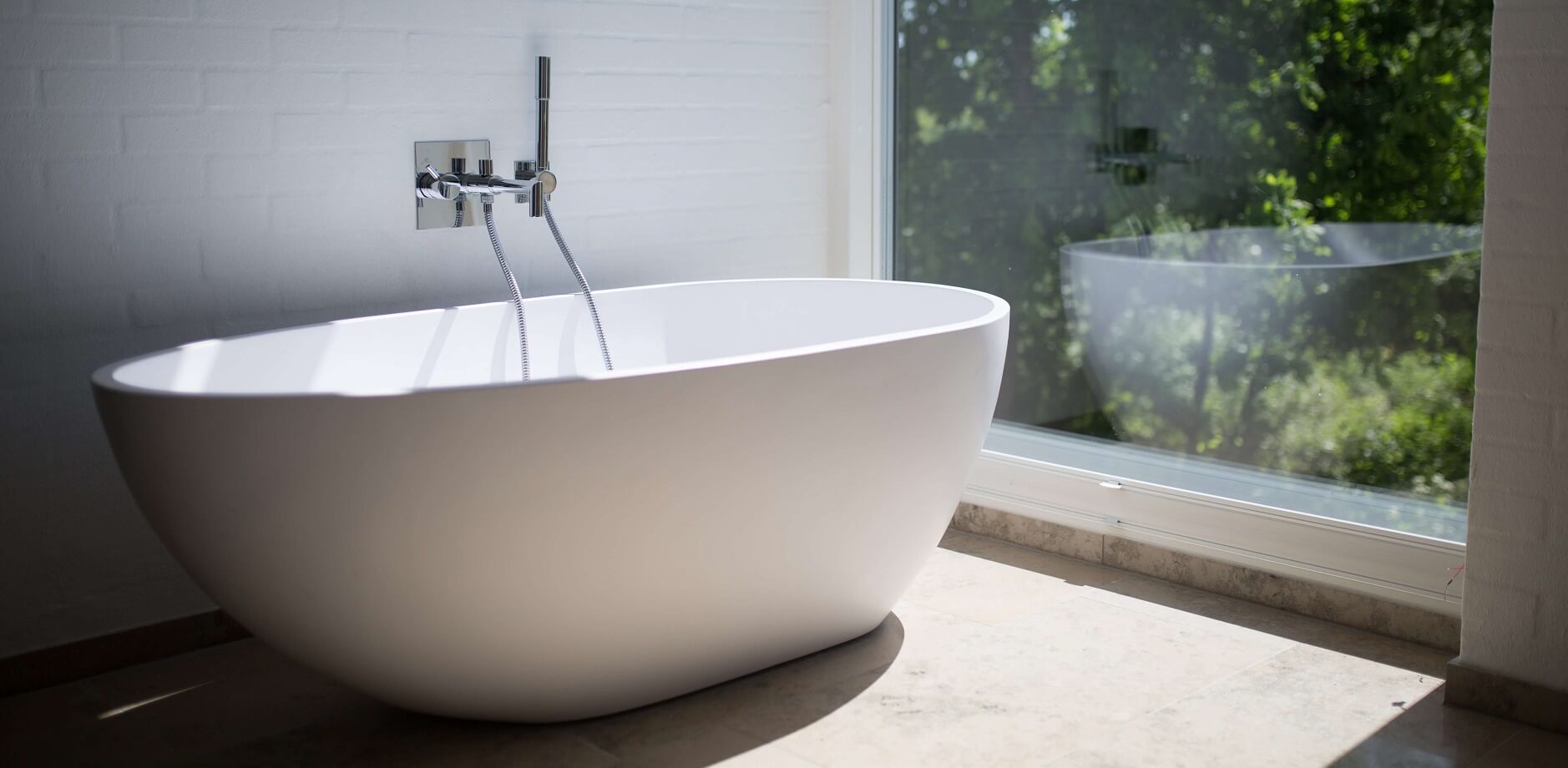 white-ceramic-bathtub-beside-clear-glass-wall (1)